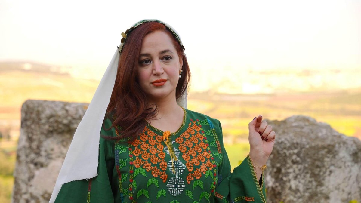 Doa'a — green 3D printed jacket with orange and white geometric pattern